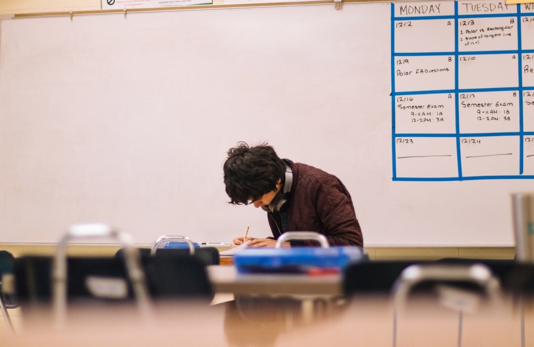 Student taking notes at desk